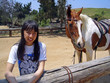 pretty girl standing next to her horse