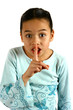 a young girl gesturing a request for silence
