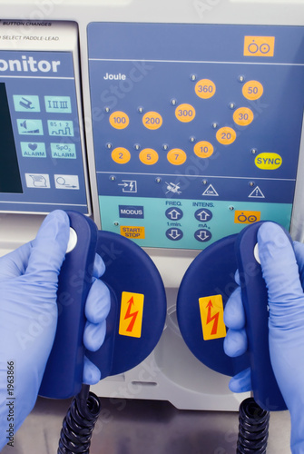 defibrillator and nurse hands