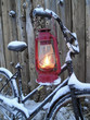 oil lamp and an old bike in winter evening