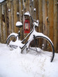 oil lamp and an old bike leaning on a shed in snow oil lamp and an old bike leaning on a shed in snow