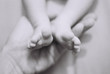 petits pieds de bébé dans main d'adulte
