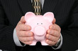 business man holding piggy bank