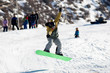 flying snowboarder on green board