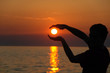 a human trying to hold and protect the sun