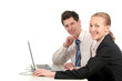 businesswoman and businessman sitting at desk with