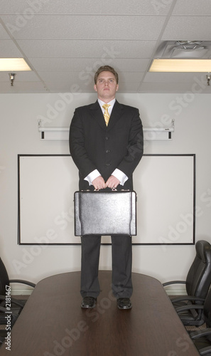 Photo: businessman stands on table businessman stands on table