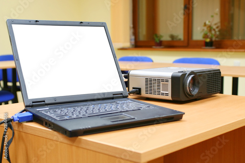 laptop connected to projector on table