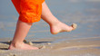 child playing with sand on beach