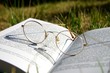 open reading glasses on a book outside open reading glasses on a book outside