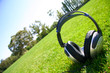 silver headphones on green grass silver headphones on green grass