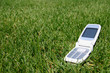 white mobile cell phone on green grass white mobile cell phone on green grass