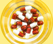 red and white pills in a glass