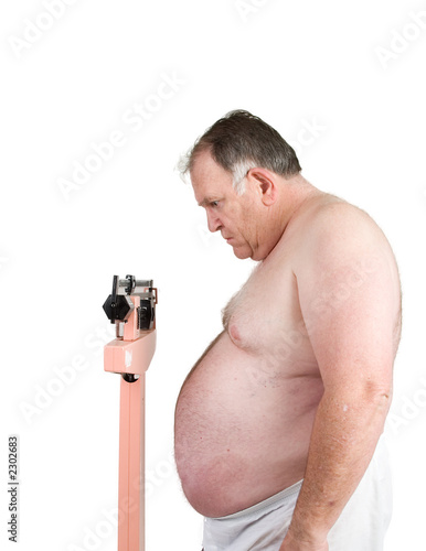 Photo: big weighing himself on white big weighing himself on white