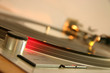 red strobe light on a silver dj turntable red strobe light on a silver dj turntable