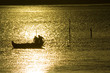 two fisherman in water with back light