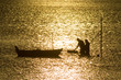two fisherman in water with back light