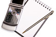 office equipment concept - spiral notebook, pen and modern phone