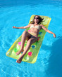 Photo : attractive, slim young lady lying on inflatable su