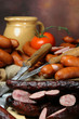 group of sausages on holiday table with  knives