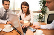 hree business persons  working together with lapto