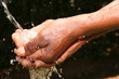 black man catching water in hand