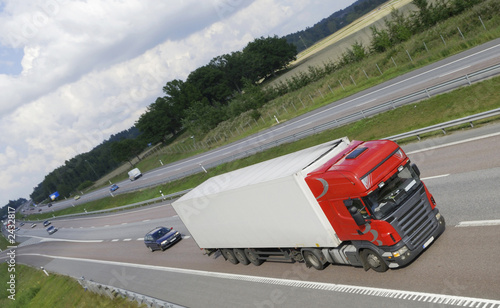 red/white clean truck speeding on highway red/white clean truck speeding on highway