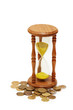 "time is money" concept - hourglass and coins