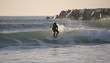 sunset surfer with black suit