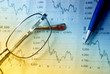 pen, eyeglasses and graphs