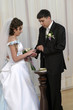 groom placing ring on brides hand