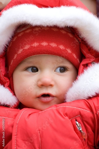 little girl wearing a red jacket