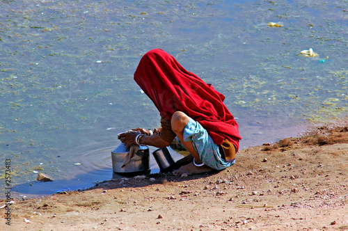 india, rajasthan, thar desert: woman searching water in a very p