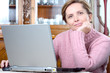 mature woman works on laptop