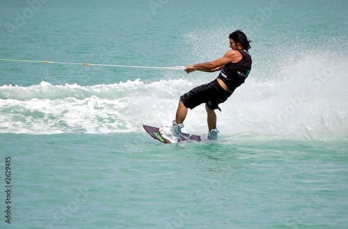 Photo: man on a wake board man on a wake board