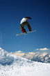 snowboarder jumping high - a winter mountains action scene