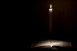 holy bible lit by a candle holy bible lit by a candle