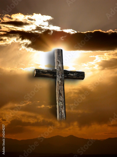 Photo: rugged cross with sunshine, clouds, and mountains rugged cross with sunshine, clouds, and mountains