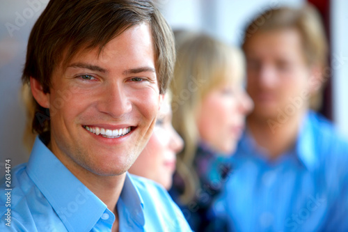 portrait of a young man in front of a workgroup