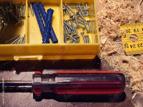 Photo: a set of screws,a ruler,screwdriver on a table a set of screws,a ruler,screwdriver on a table