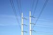 two white electricity pylons and stretching wires