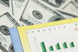 business concept - bar charts and dollar bank notes