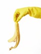 hand in yellow rubber glove with a banana peel 2 hand in yellow rubber glove with a banana peel 2