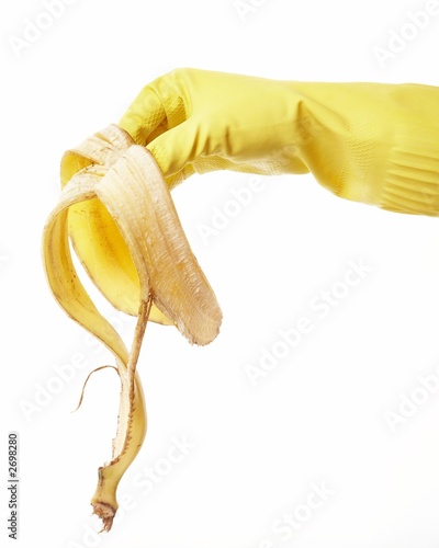 Photo: hand in yellow rubber glove with a banana peel 5 hand in yellow rubber glove with a banana peel 5