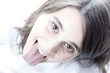 high key portrait of a teen sticking out her tongue