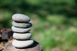 zen stones balanced on log