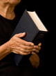 Photo: woman holding bible woman holding bible