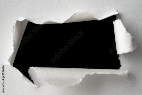 torn hole in paper.