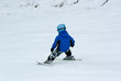 a boy downhill skiing