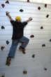 boy against artificial climbing wall